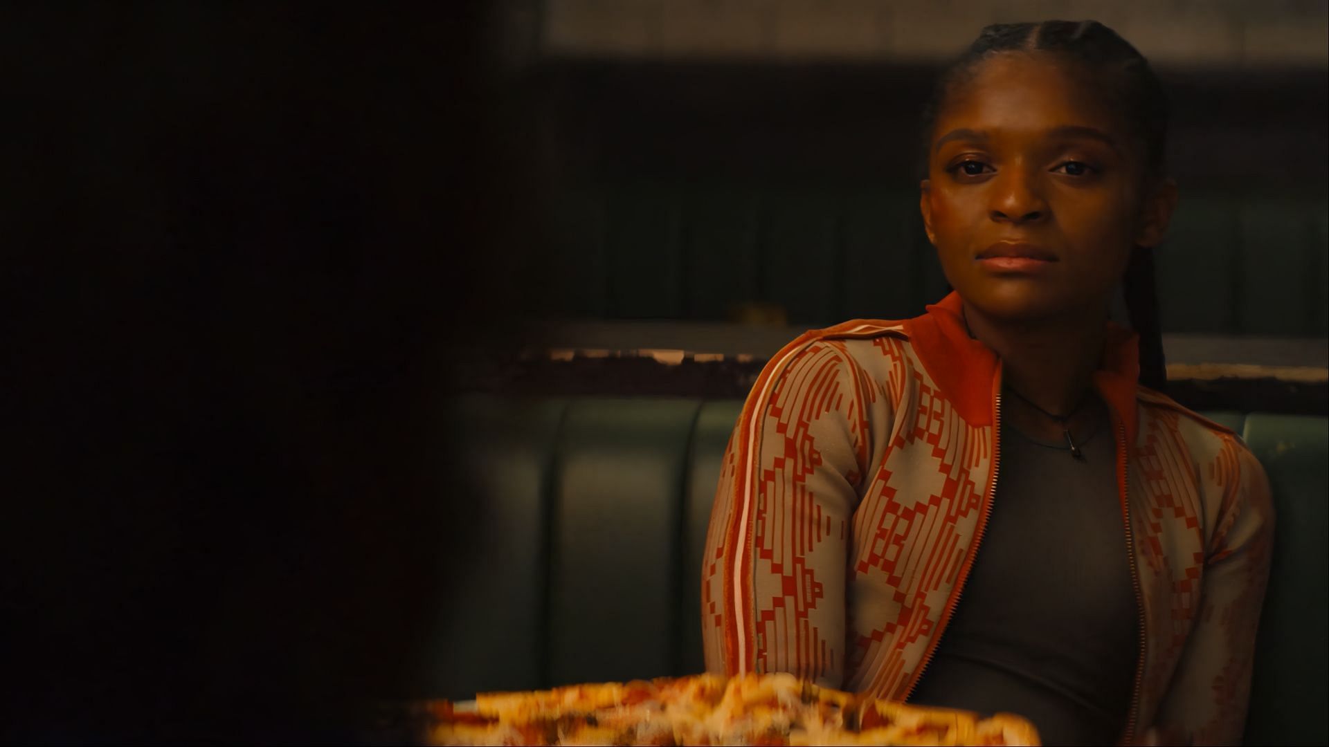Riri Williams sits across from Mephisto in a pivotal scene from Ironheart's finale. (Image via Disney+)